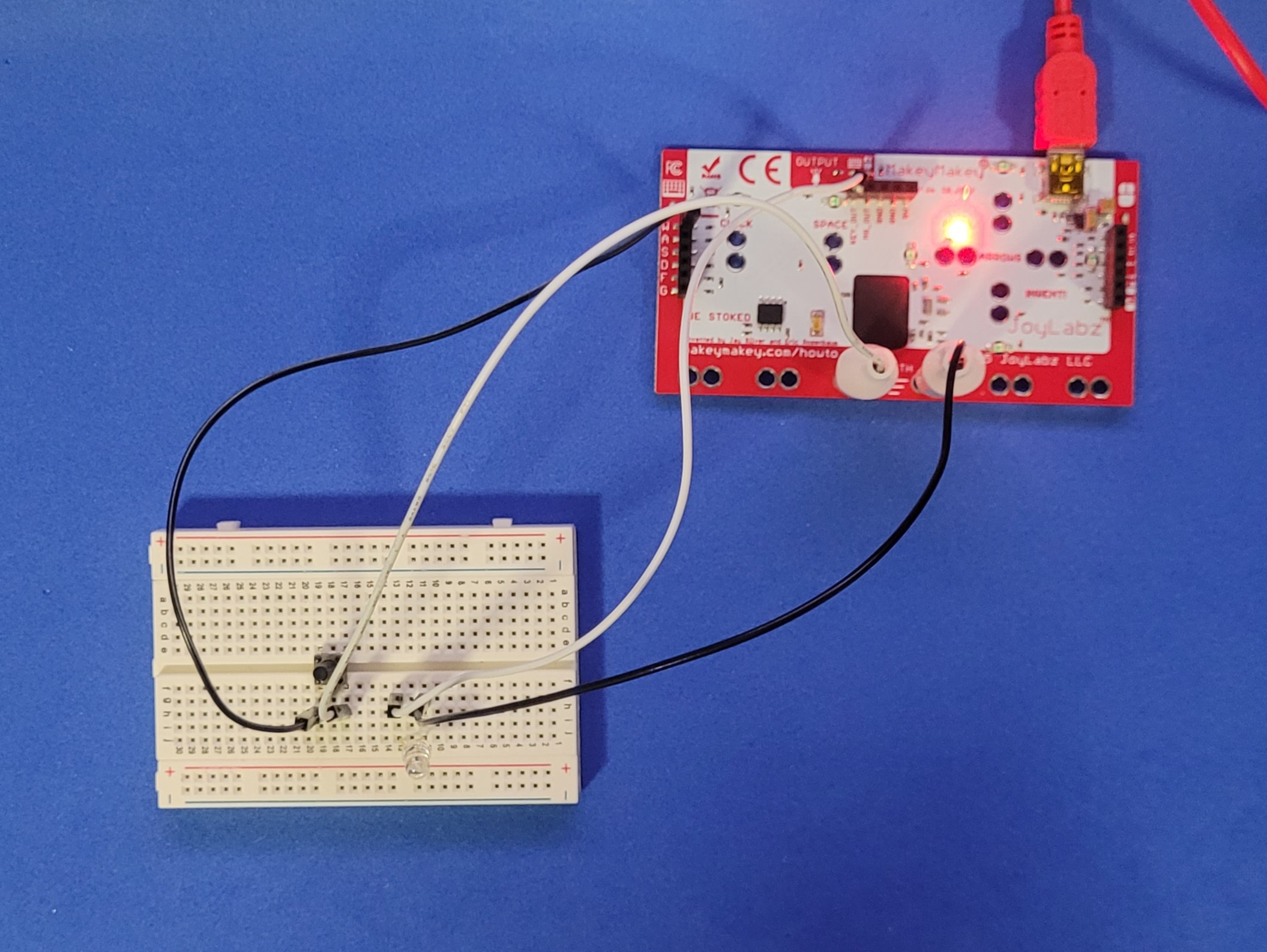 A photo of a simple LED breadboard circuit powered by the MakeyMakey