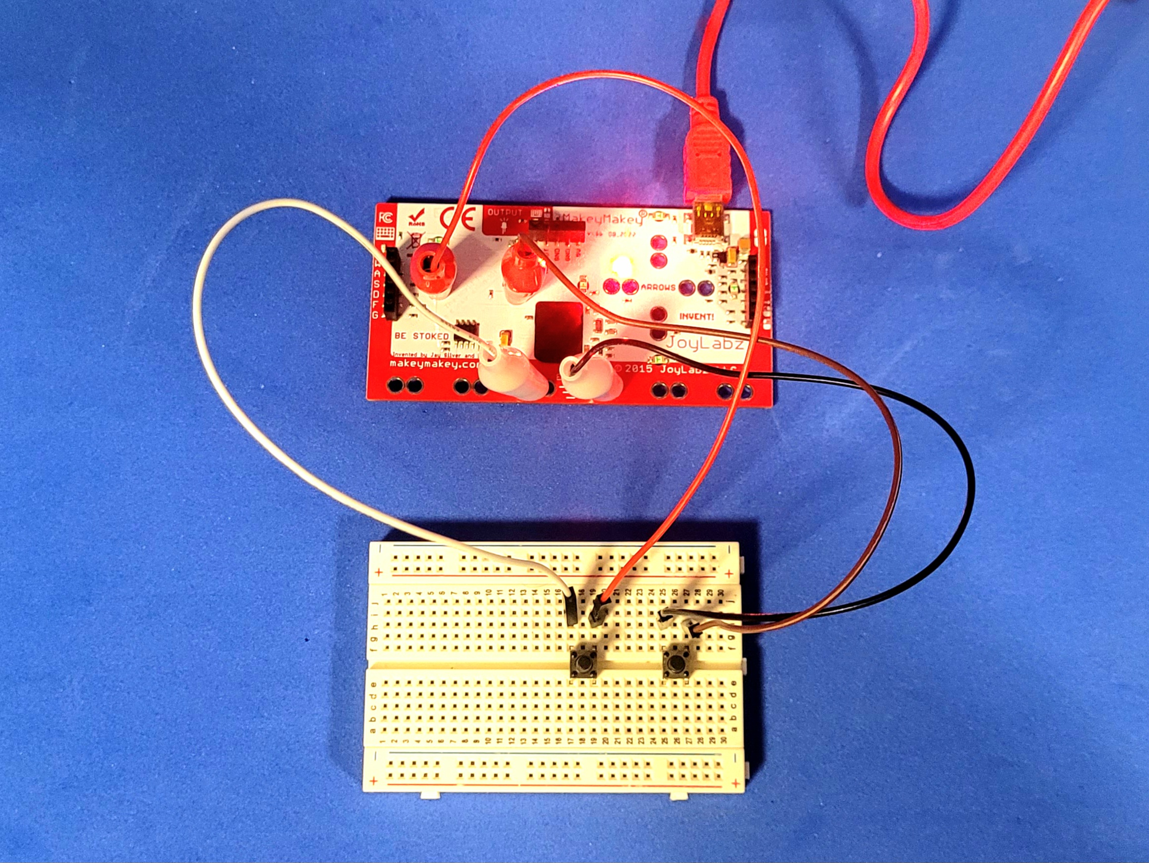 A photo of a simple two key button circuit using a breadboard and MakeyMakey